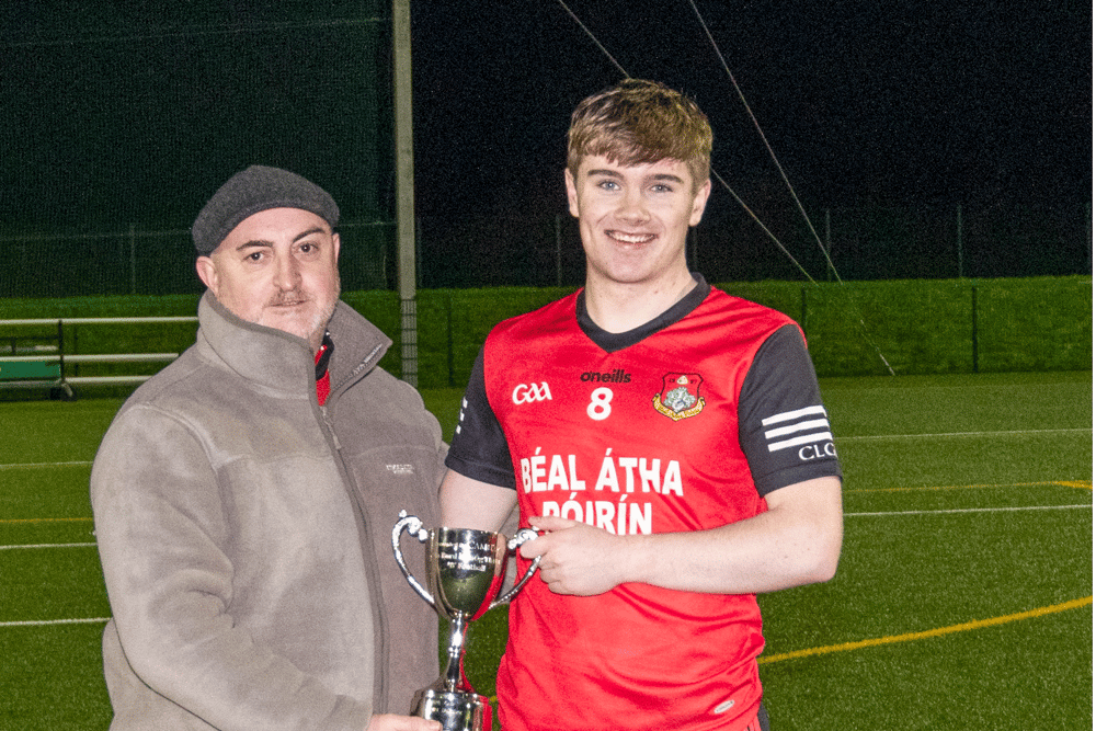 Ballyporeen captain Jason King receives the cup from Declan Hickey, Vice Chairman of South Tipperary Bord na nÓg. Picture: Michael Boland