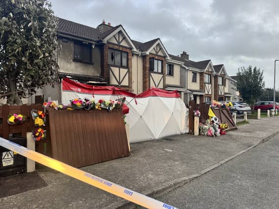 Floral tributes outside a house